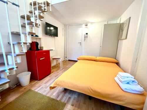 a bedroom with a yellow bed and a red cabinet at Orvieto10 in Milan