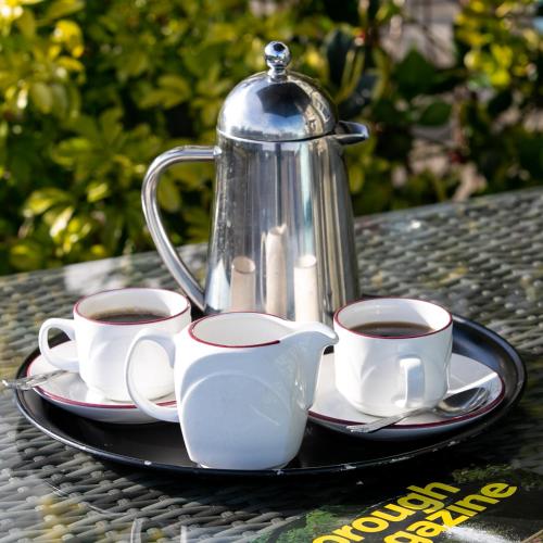 a tray with three cups of coffee and a tea pot at Shelleven Guest House in Bangor