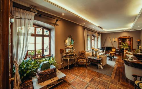 a living room filled with furniture and a large window at Hotel Victoria in Cuenca