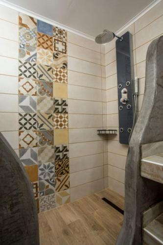 a bathroom with a sink and a shower with tiles at Faliraki Blue Villas in Faliraki