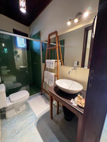 a bathroom with a sink and a shower and a toilet at Casa Fufi in Jericoacoara