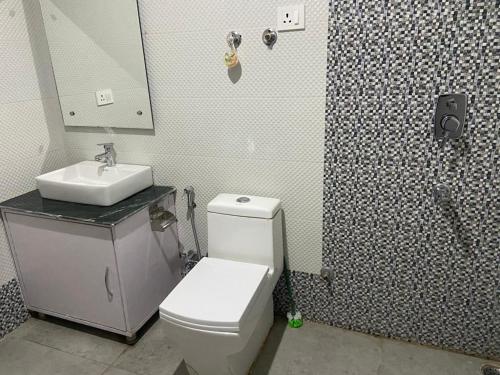 a bathroom with a toilet and a sink and a shower at Nima's Villa in Leh
