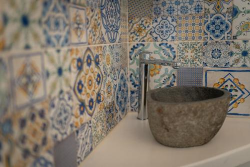 a bowl sitting on top of a toilet in a bathroom at RomAntica in Polignano a Mare