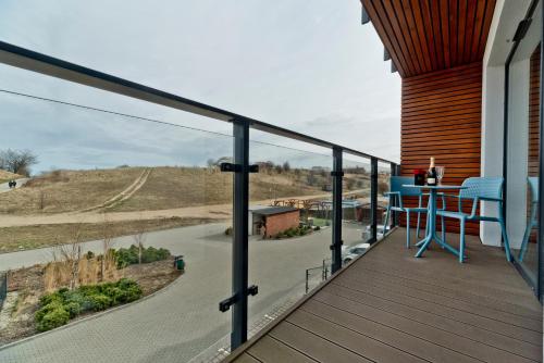 a balcony with a table and a view of a road at Aparthotel Anchoria BlueApart in Mechelinki