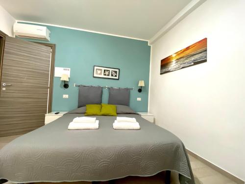 a bedroom with a bed with two towels on it at Bed & Breakfast La Rocca in Taormina