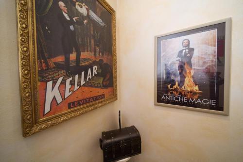 a pair of posters on a wall in a room at B&BMagicHouse in Novara