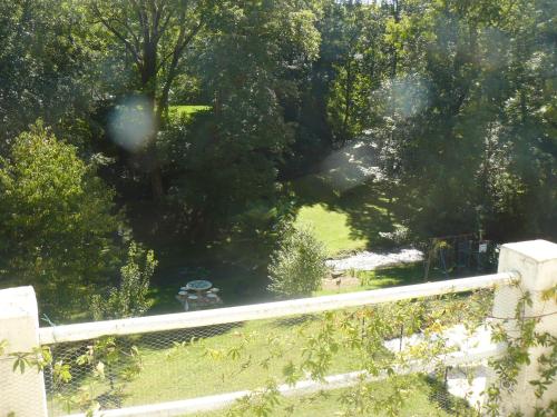 a view of a park with trees and a fence at Chambres d'Hôtes & Gites Pouget in Les Eyzies-de-Tayac
