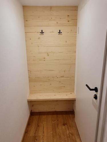 a hallway with a bench in the corner of a room at Allgäuer Heimat in Rettenberg