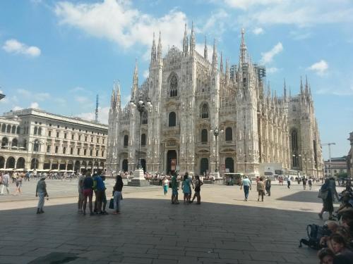 a group of people standing in front of a cathedral at Flat in Duomo in Milan