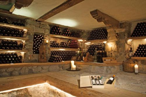 a wine cellar with a bunch of wine bottles at Hotel Tipotsch in Stumm