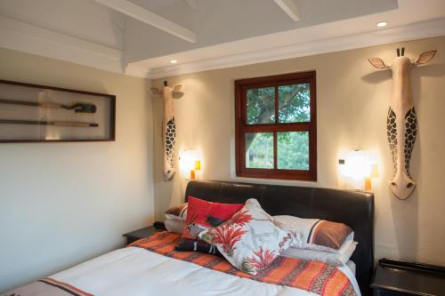 a bedroom with a bed with deer heads on the wall at Strawberry Fields Country Manor Guest House in Johannesburg