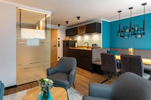 a kitchen and living room with blue walls at Seegut Kübler in Ort