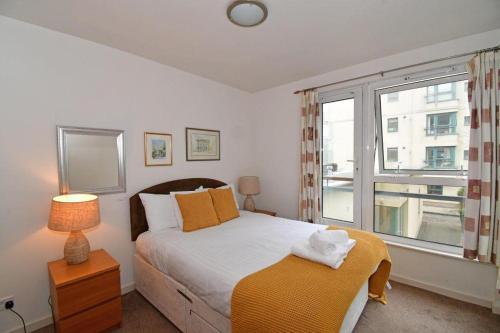 a bedroom with a large bed and a window at Dreamhouse Apartments Edinburgh Holyrood Park in Edinburgh