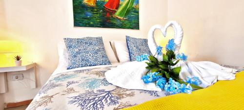 a bedroom with a bed with blue flowers and a painting at Luna Caprese Room in Anacapri