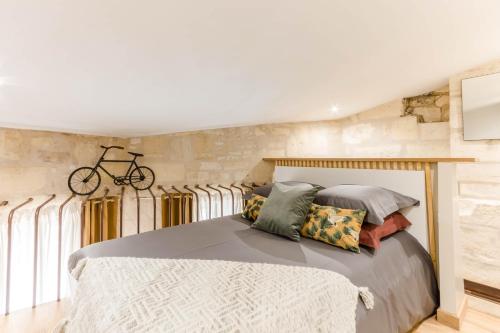 - une chambre avec un lit et un vélo sur le mur dans l'établissement LA Sainte Catherine 264, à Bordeaux