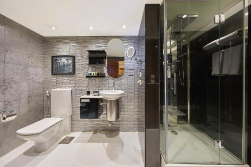 a bathroom with a toilet and a sink and a shower at Golden Park Hotel Cairo, Heliopolis in Cairo