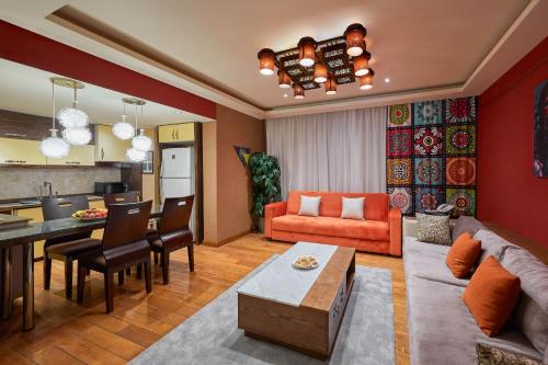 
a living room filled with furniture and a fire place at Golden Park Hotel Cairo, Heliopolis in Cairo
