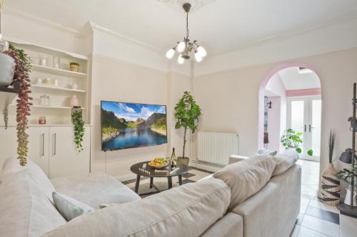 a living room with a white couch and a table at Malleus House in Barrow in Furness