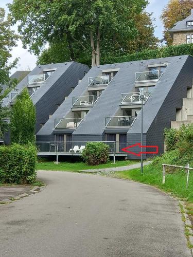 a large building with a pitched roof at Bord de lac - 4/6pers SAUNA - terrasse 20m2 in Vielsalm