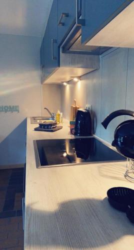a kitchen with a sink and a counter top at Bord de lac - 4/6pers SAUNA - terrasse 20m2 in Vielsalm
