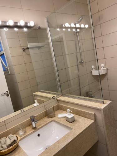 a bathroom with a sink and a mirror at Almaza bay Beach Town Chalet in Marsa Matruh