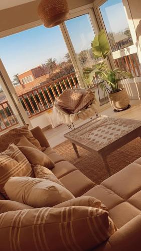 a living room with a couch and a large window at Almaza bay Beach Town Chalet in Marsa Matruh