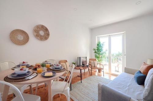 a living room with a table and a couch at Enjoy the Sunny Balcony, By TimeCooler in Lisbon