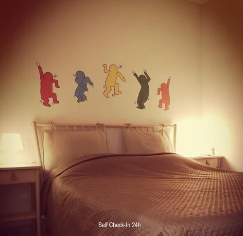a bedroom with a bed with a wall with stickers on it at Piccola Pisa (zona Ospedale Cisanello) in Pisa