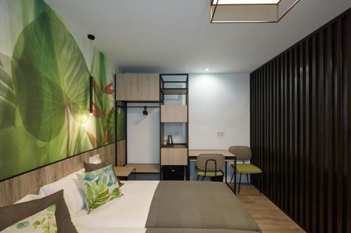 a bedroom with a large bed and a table at Enmathi Alicante Benalua in Alicante