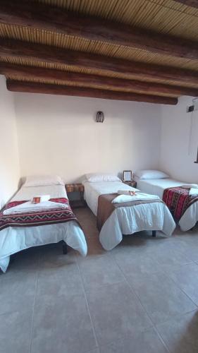 A bed or beds in a room at Hostería Aguas Coloradas