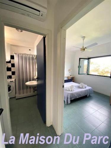 a room with a bedroom with a bed and a window at La Maison Du Parc in SantʼAndrea Apostolo dello Ionio
