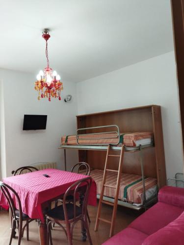 a dining room with a table and a bunk bed at Appartamenti da Ermanno in Bonassola