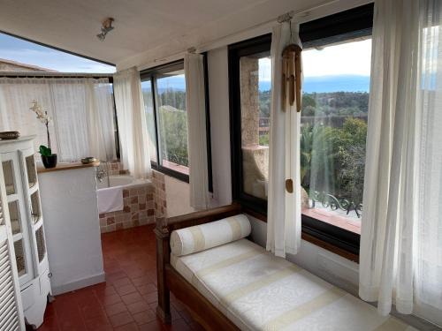 a bathroom with a tub and a window with a view at Villa La Rose des Vents in Tourrettes