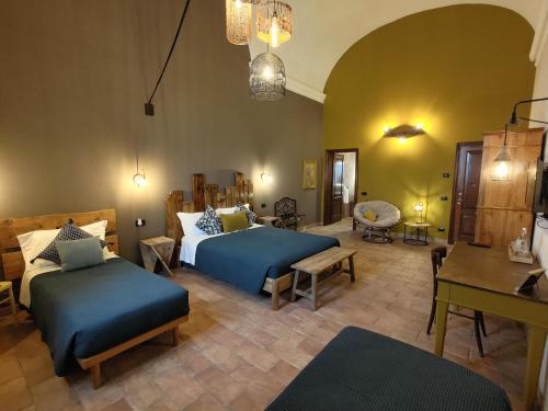 a bedroom with two beds and a living room at Casale Boschi - Rifugio di Pianura in Cotignola