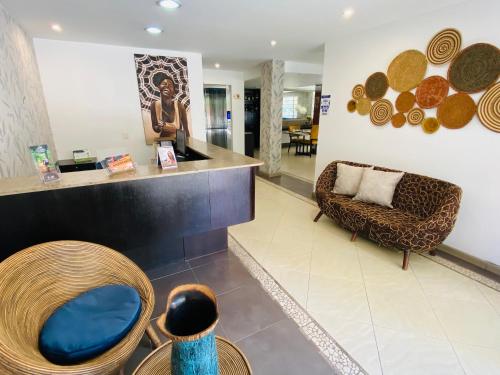 a lobby of a store with a chair and a couch at Hotel Retiro 84 by MIJ in Bogotá