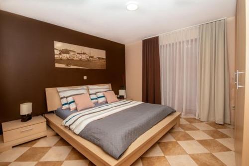 a bedroom with a large bed in a room at M&M Apartments in Biograd na Moru