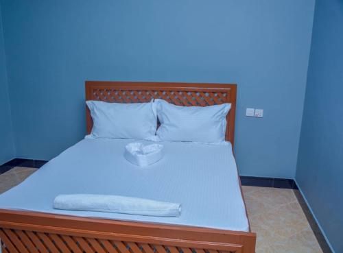 a blue room with a bed with a box on it at Johnsons StopPoint in Zame