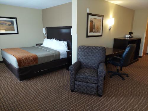 a hotel room with a bed and a chair and a desk at Best Western Plus Vintage Valley Inn in Zillah