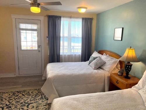 a bedroom with two beds and a window at Come from Away B&B in Digby
