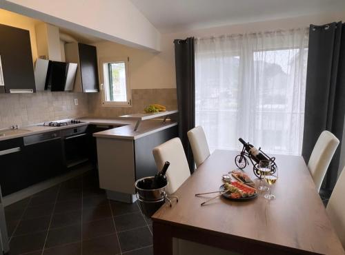 a kitchen with a table with a bowl of fruit on it at Apartments Mihi in Podstrana