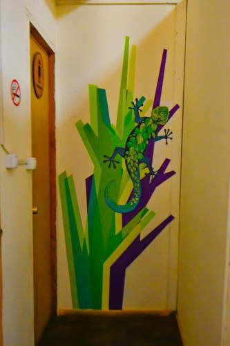 a painting of a lizard on a wall at Gecko Hostel in Pucón