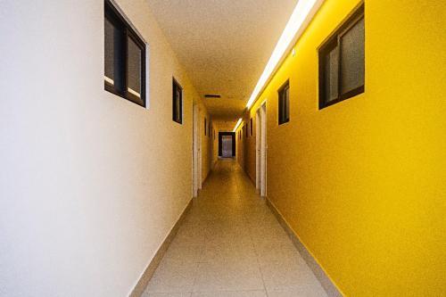 an empty hallway in a building with yellow walls at Flat em Lagoa Nova, Mobiliado e Aconchegante in Natal