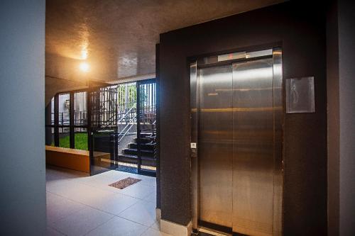 a metal elevator in a building with a window at Flat em Lagoa Nova, Mobiliado e Aconchegante in Natal