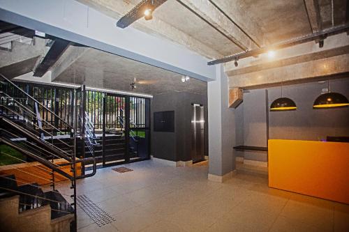 a lobby with a staircase and a yellow cabinet at Flat em Lagoa Nova, Mobiliado e Aconchegante in Natal