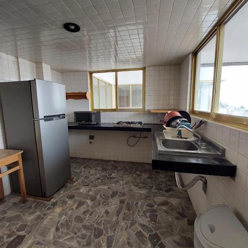 a kitchen with a refrigerator and a sink at Casa Villaliz in Toluca