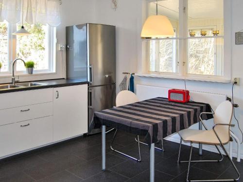 a kitchen with a table with a red box on it at 7 person holiday home in Vittsjö-By Traum in Vittsjö