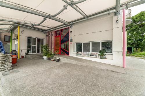 a building with a garage with a red door at 睡海邊包棟民宿 sleep on beach B&B in Suao