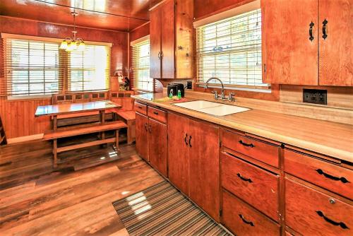 a large kitchen with wooden cabinets and a sink at Frank's Old Bear-149 by Big Bear Vacations in Big Bear Lake