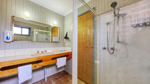 a bathroom with a shower and a sink at Barham Riverland Motel in Barham