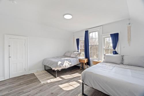 a bedroom with two beds and a window at Cozy Gem in the Heart of East Rock with FREE Parking near Yale and DT in New Haven